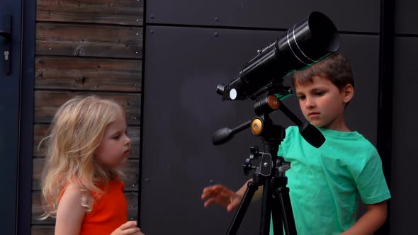 Cute Little Children are Setting Up a Telescope to Look at the Sky