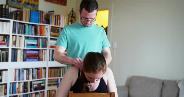 Man massaging pregnant woman shoulder