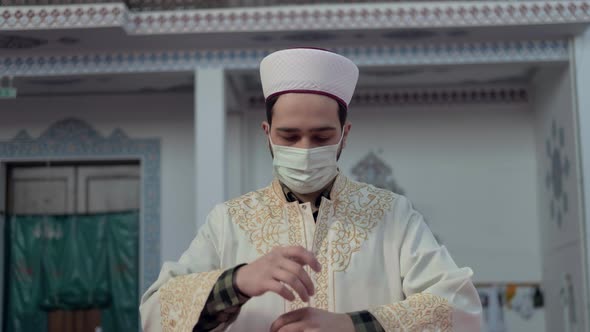 Masked Muslim İmam Praying in Mosque