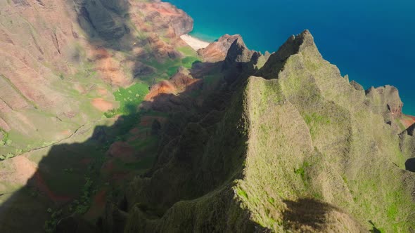 Drone Video Above Helicopter Flying Low Below in Green Tropical Napali Canyon