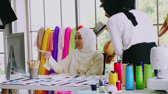 Muslim women fashion designers are in process of creating new clothes collection.