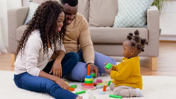 African Family Playing with Baby Daughter at Home