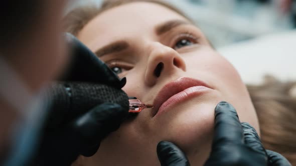 Cosmetologist Making Lips Permanent Makeup