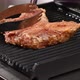 Fried piece of pork meat on the bone on the grill, barbecue - VideoHive Item for Sale