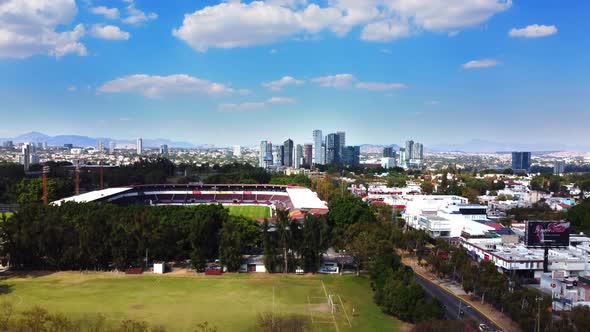 Downtown and soccer stadium. Players can be seen playing in the soccer court.