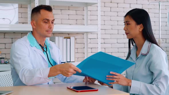 Doctor in Professional Uniform Examining Patient at Hospital