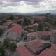Drone flying over roofs of granite rural houses in Sortelha village with mountains in background - VideoHive Item for Sale