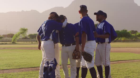 Baseball players embracing and celebrating after the match