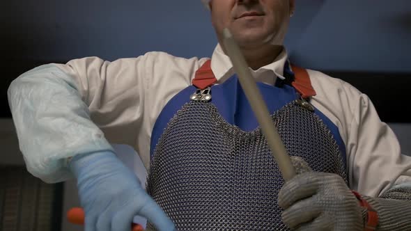 Man Sharpens Knife on Proffesional Sharpener