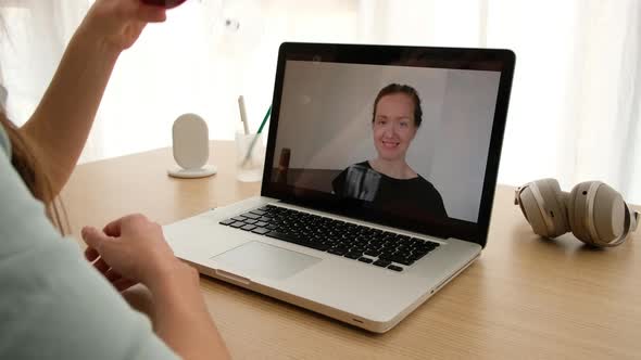 Women Talking on a Webcam with Wine