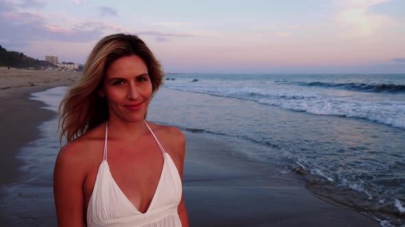 Attractive Woman Enjoying The Beach At Sunset