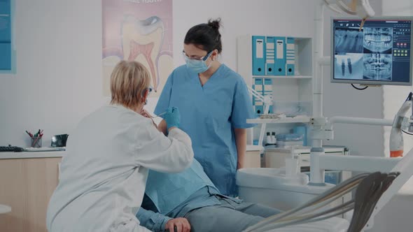 Dentist Doing Oral Care Examination on Patient with Toothache