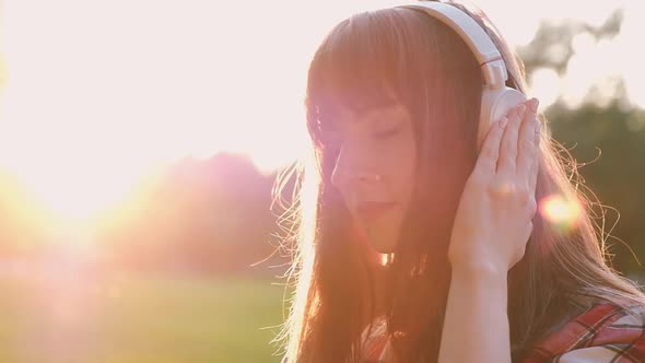 Close-up of a beautiful young charming woman listening to her favorite music