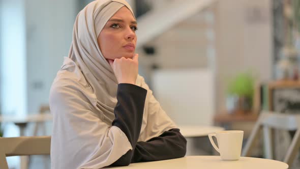 Pensive Young Arab Women Sitting and Thinking 