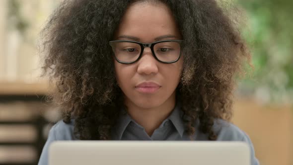 Close Up of African Woman with Laptop Looking at the Camera