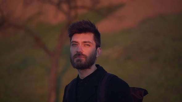 Attractive Male Standing in Park Watching Sunset Slow Motion