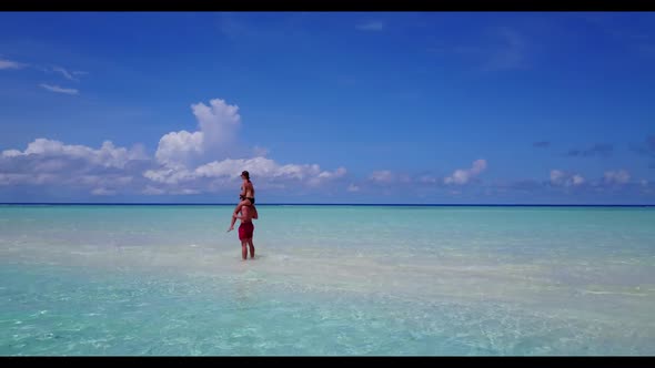 Teenage lovers suntan on perfect coast beach lifestyle by blue sea with bright sand background of th