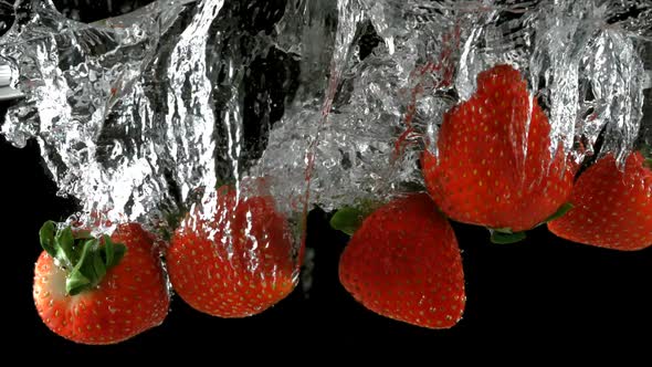 Slo-motion strawberry through water