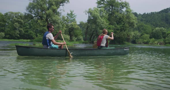 Couple Kayaking on Lake on River and Having Adventure in Nature