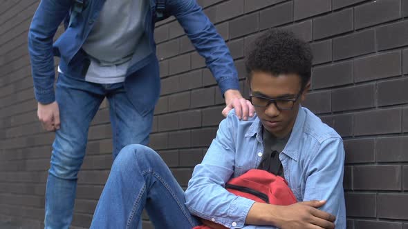 Friendly Student Giving Hand Afro-American Teenager, Supporting Bullying Victim