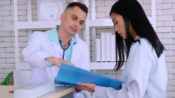 Doctor in Professional Uniform Examining Patient at Hospital