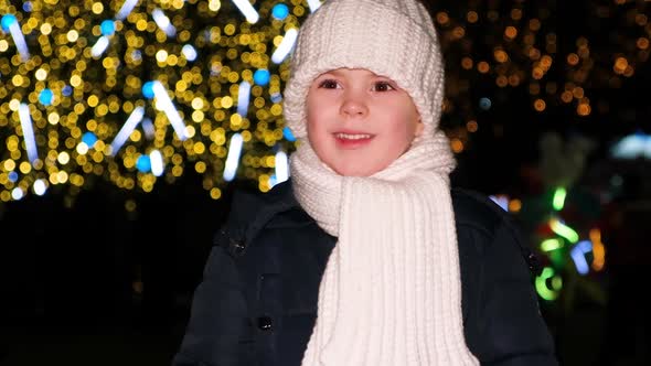 A Beautiful Preschool Child of 4 Years Old Has Fun Near the Christmas Tree in the Evening