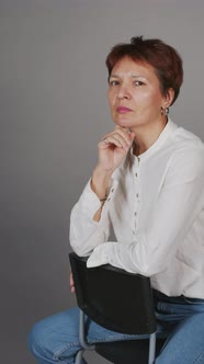 Vertical Portrait of Serious Mature Woman with Short Hair