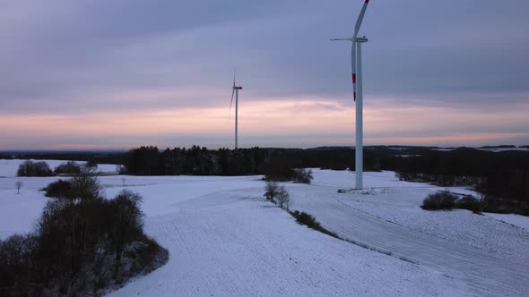 Aerial view of a wind farm in winter. Aerial view of rotating wind turbines.