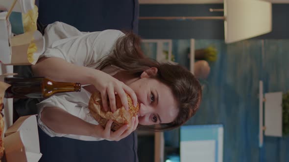 Vertical Video Person Watching Comedy on TV and Eating Delicious Burger