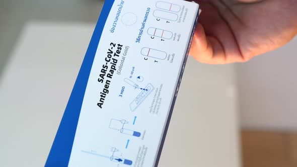 Man Hand Open Box with Antigen Rapid Test on Covid