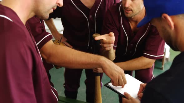 Coach discussing game plan with players