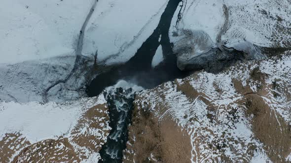 Drone footage of waterfall in Iceland from above.