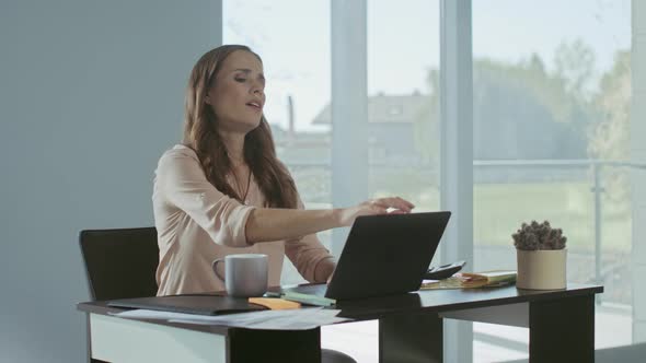 Business Woman Closing Laptop Computer. Tired Lady Finishing Work at Workplace