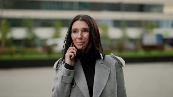 Walk in Downtown and Good Mood in Autumn Day Elegant Woman is Talking By Phone on Street