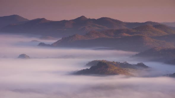 Golden light sunrise And the fog flows on high mountains.