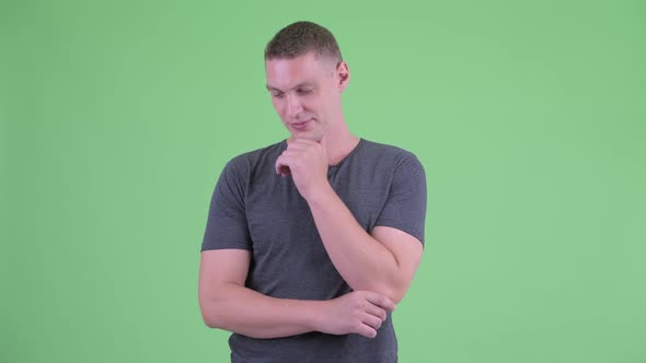 Portrait of Stressed Young Man Thinking and Looking Down