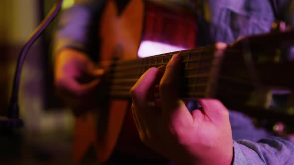 Man playing guitar in a music studio