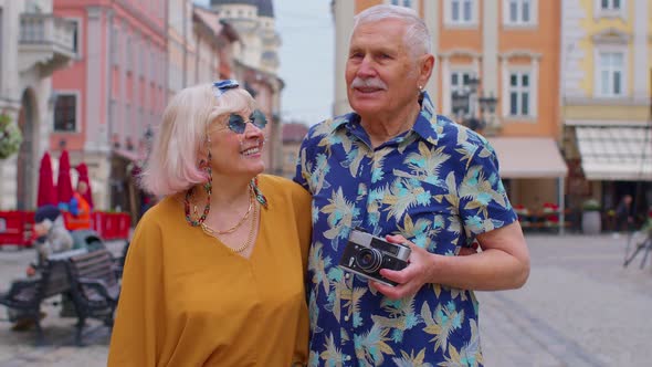 Senior Old Stylish Tourists Man Woman Grandmother Grandfather Family Having a Walk in Summer City