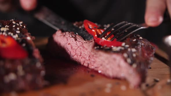 juicy piece of beef ready-made steak on a fork