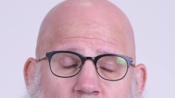 Eyes of Mature Bald Bearded Man with Eyeglasses Thinking