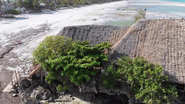 The Rock Restaurant in Ocean Built on Cliff at Low Tide on Zanzibar Aerial View