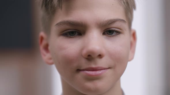 Headshot Portrait of Smiling Confident Teenage Caucasian Boy Looking at Camera