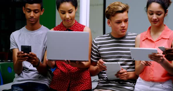 Students using laptop, mobile phone and digital tablet