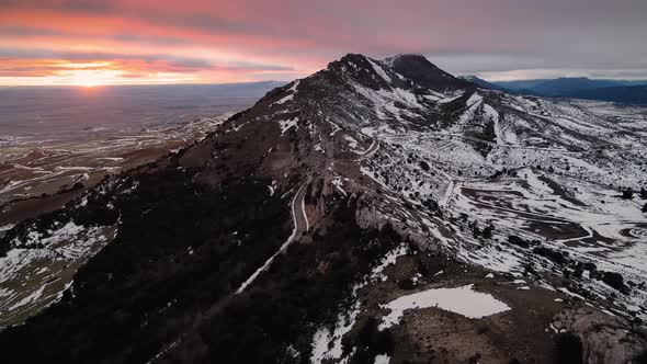 Aerial View Over Snow Covered High Mountains at Sunset