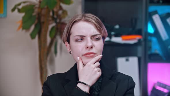 A Young Business Woman Thinking About Something in the Office