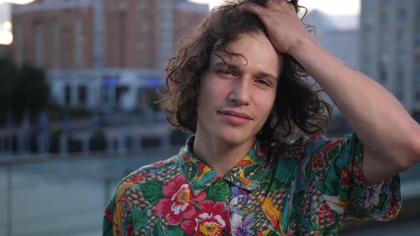 Portrait of Young Man with Curly Hair Outdoor