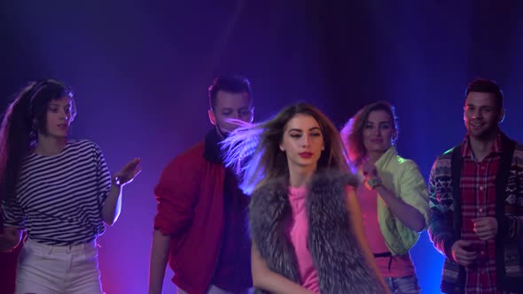 Group of People Dancing To Cool Music with Disco Lights