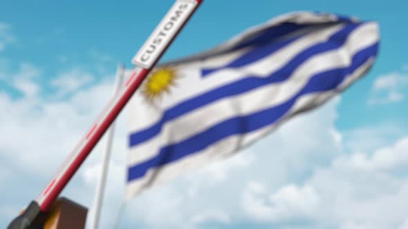 Closing Boom Barrier with CUSTOMS Sign at Flag of Uruguay alt