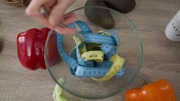 Top View Mixing Measuring Tapes in Transparent Salad Bowl