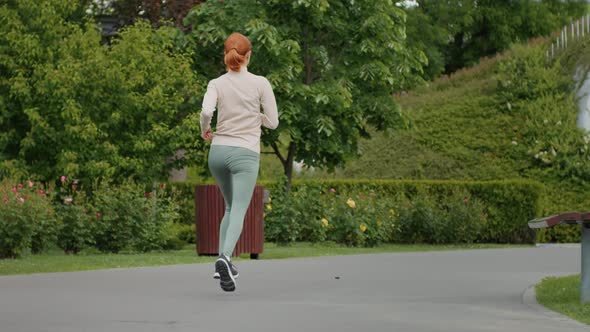 Woman jogging in the park, anorexic physical condition